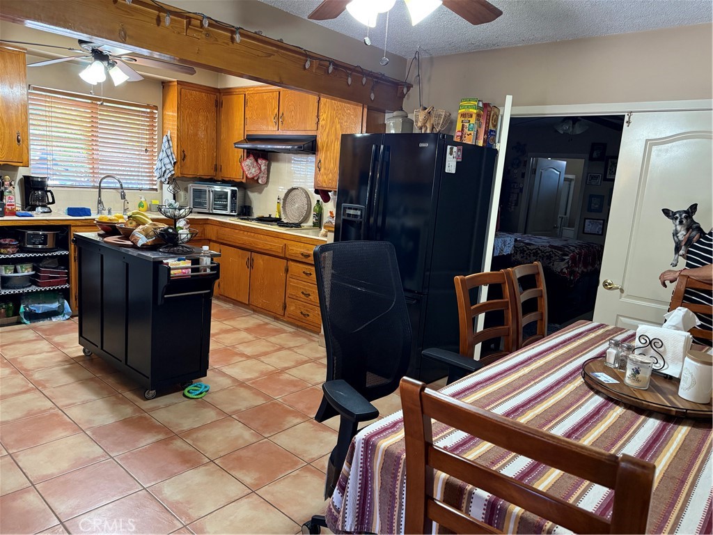 4535 Ramsdell Avenue La Crescenta, CA 91214 - Photo 20 of 28 a kitchen with stainless steel appliances a stove a refrigerator a sink a dining table and chairs