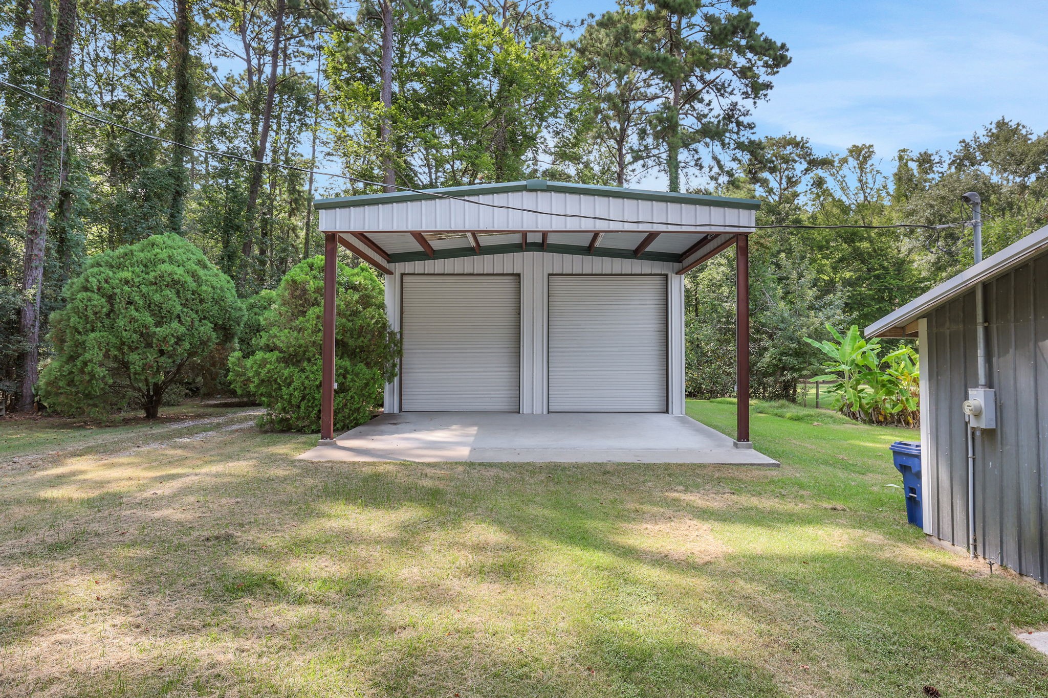 200 Johnson Road Coldspring, TX 77331 - Photo 45 of 47 The 1200sf metal building has two large roll up doors along with a covered area out front and is on a concrete slab