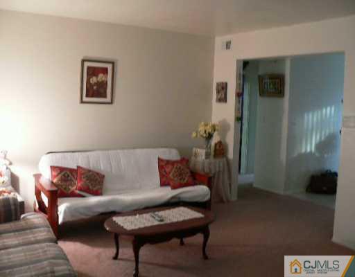 37 Judson Street, Unit 8A Edison, NJ 08837 - Photo 1 of 7 a living room with furniture and a potted plant