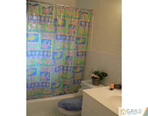 37 Judson Street, Unit 8A Edison, NJ 08837 - Photo 5 of 7 a bathroom with a shower curtain and a sink