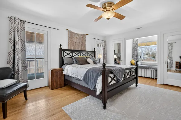 a bedroom with a large bed and a chandelier
