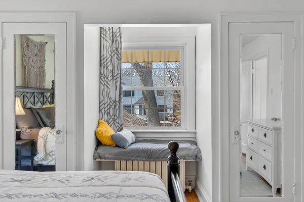 a bedroom with a bed and wooden floor