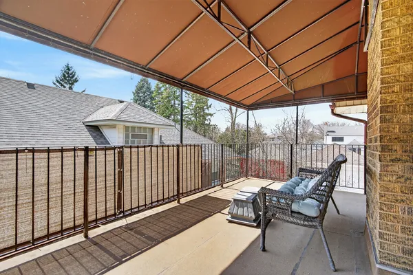 a balcony view with a seating space