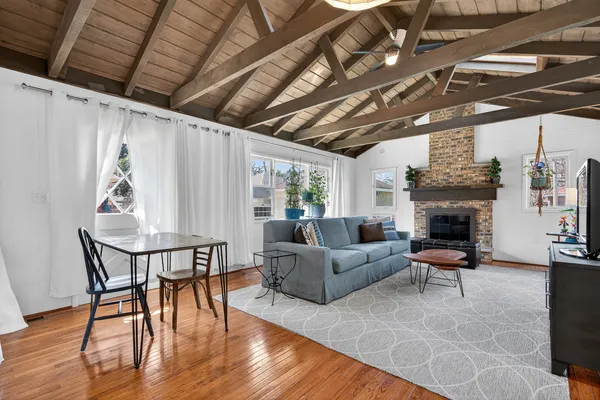 a living room with furniture wooden floor and a fireplace