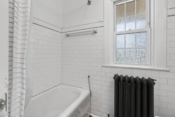 a bathroom with a bathtub and shower