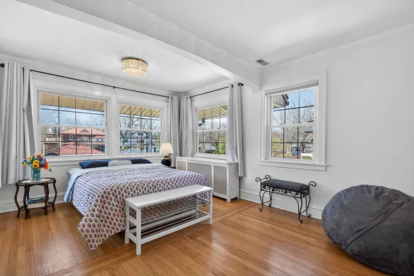 a bedroom with a bed and a lounge chair
