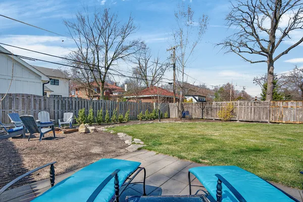 a backyard of a house with table and chairs