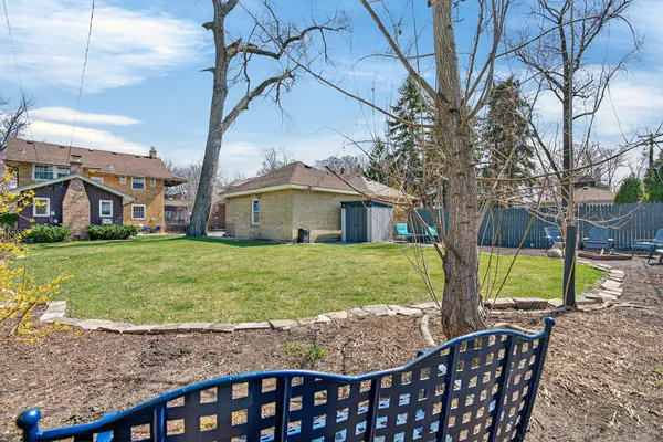 a view of a house with backyard and sitting area