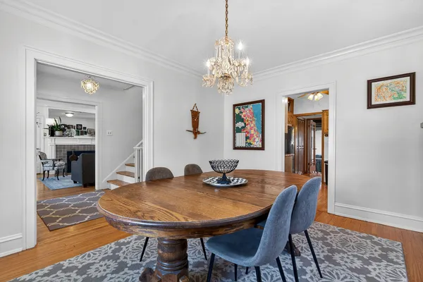 a view of a dining room with furniture and chandelier