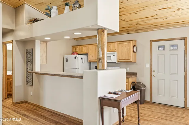 a kitchen that has a sink a stove and refrigerator