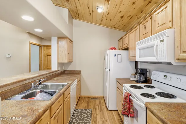 a kitchen with a stove a refrigerator and a sink