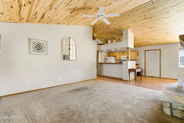 an empty room with fireplace and windows