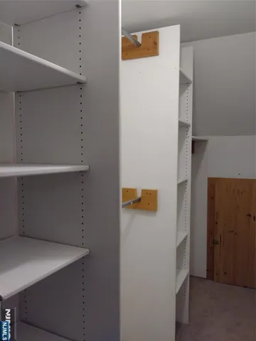 a view of storage and utility room with a refrigerator