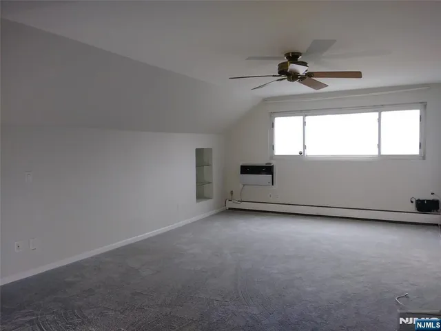 a view of an empty room and a window