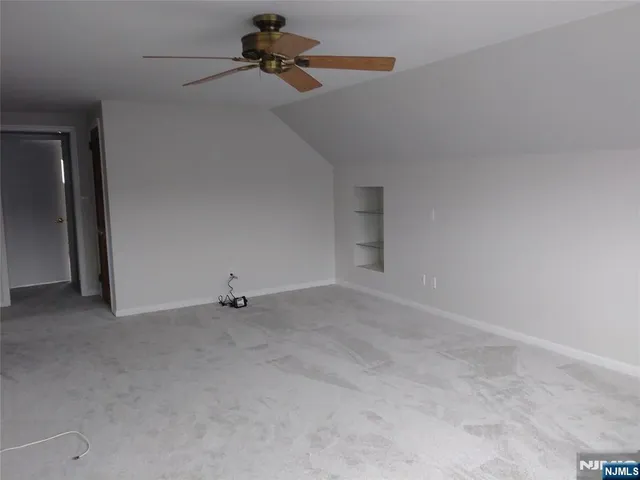 a view of room with a ceiling fan and window