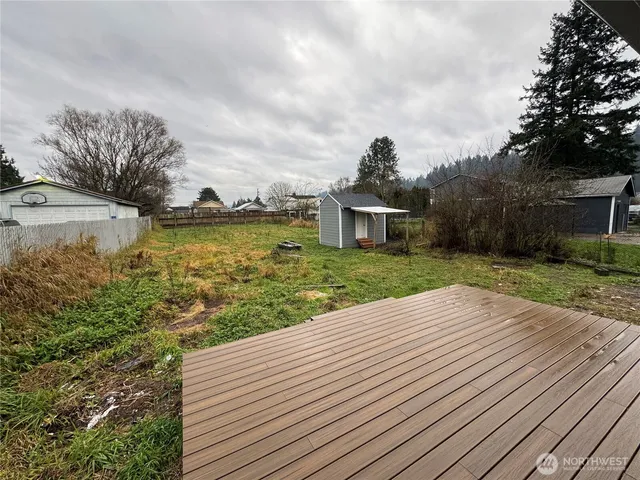 a view of a balcony with wooden floor and lake view