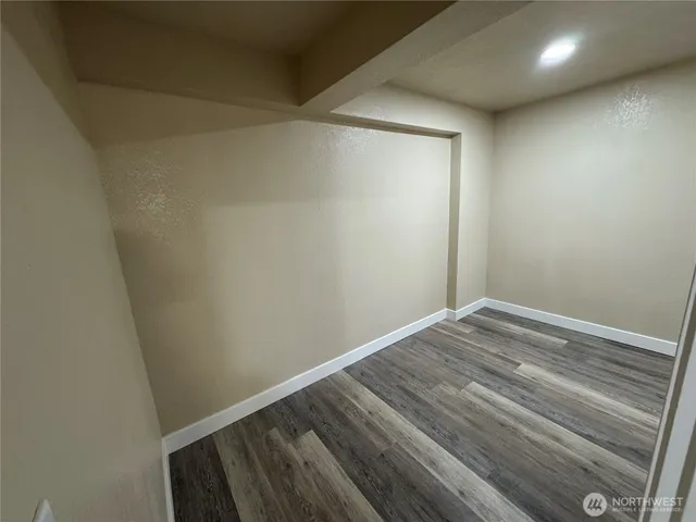 a view of room with wooden floor