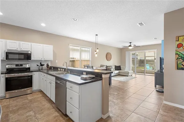 a kitchen with a stove a sink and a refrigerator