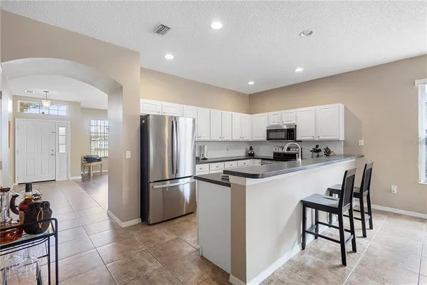 a kitchen with refrigerator and cabinets