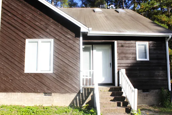 a view of house with yard