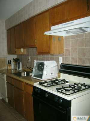 1812 Raspberry Court Edison, NJ 08817 - Photo 3 of 8 a kitchen with a stove and a sink