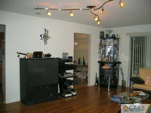 1812 Raspberry Court Edison, NJ 08817 - Photo 5 of 8 a living room with lots of furniture and gym equipment