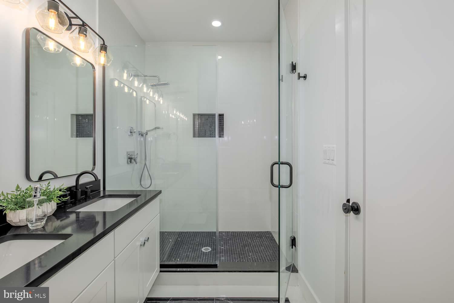 428 Manor Place Northwest, Unit 2 Washington, DC 20010 - Photo 15 of 27 a bathroom with a granite countertop sink a mirror and shower