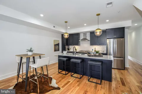 a kitchen with stainless steel appliances kitchen island granite countertop a sink and cabinets