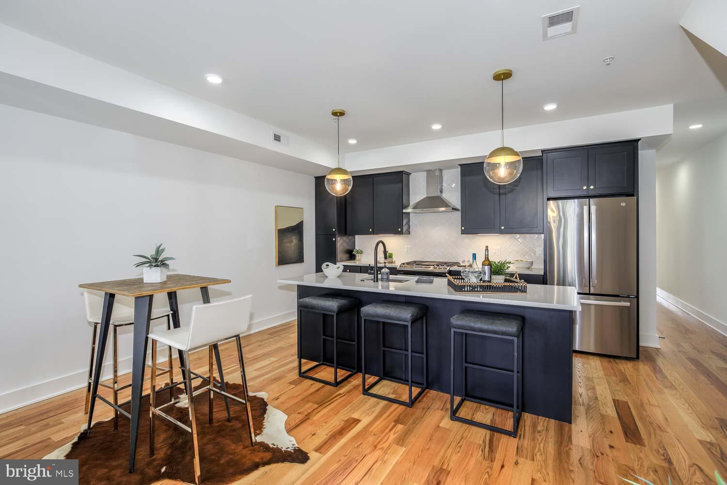 428 Manor Place Northwest, Unit 2 Washington, DC 20010 - Photo 6 of 27 a kitchen with stainless steel appliances kitchen island granite countertop a sink and cabinets