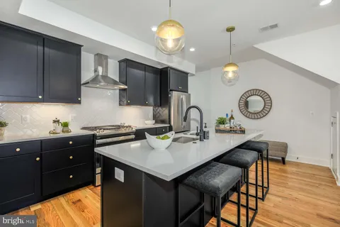a kitchen with a table and chairs