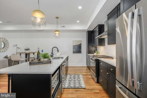 a kitchen with stainless steel appliances a sink a stove and a refrigerator