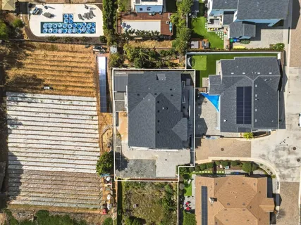 an aerial view of residential houses with outdoor space