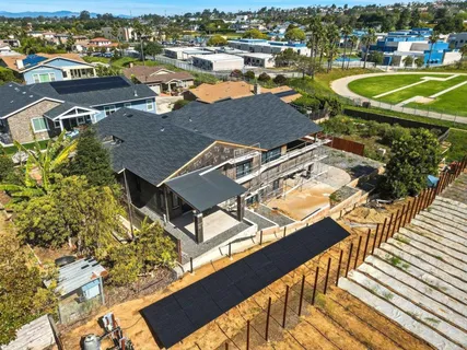 an aerial view of a house with a ocean view