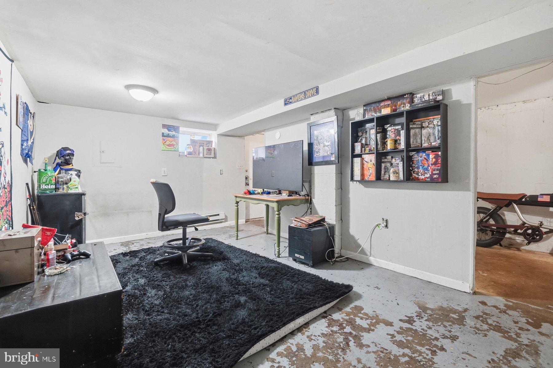 4931 Brookwood Road Baltimore, MD 21225 - Photo 23 of 25 a room with furniture a rug and white walls