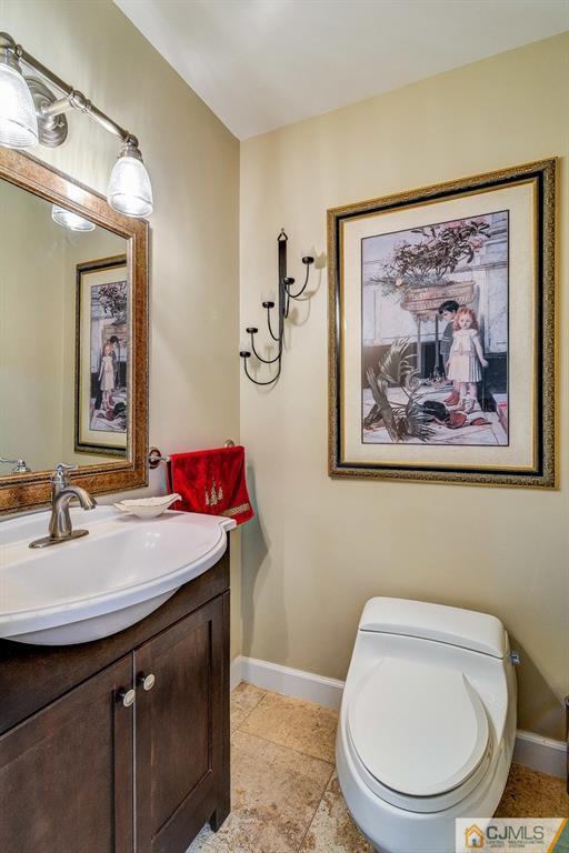 16 Mockingbird Road Edison, NJ 08820 - Photo 14 of 25 a bathroom with a toilet a sink and mirror