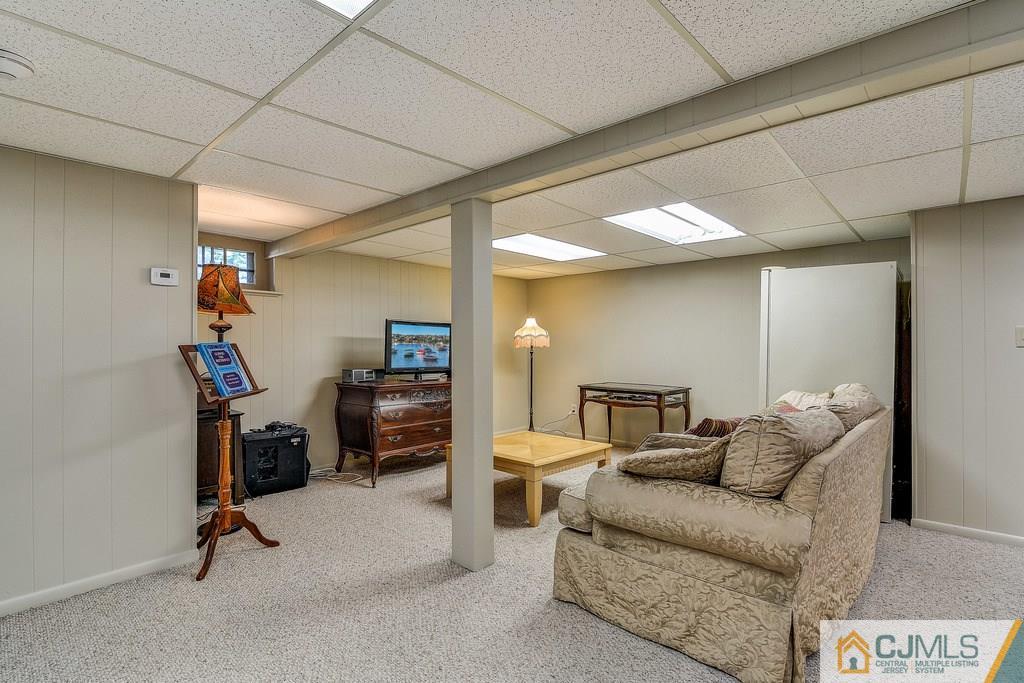16 Mockingbird Road Edison, NJ 08820 - Photo 23 of 25 a living room with furniture and a flat screen tv