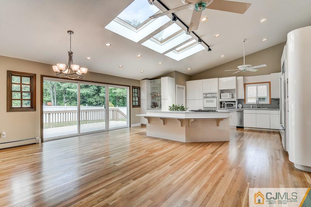 16 Mockingbird Road Edison, NJ 08820 - Photo 8 of 25 a large kitchen with stainless steel appliances granite countertop a large counter top a wooden floors and a large window