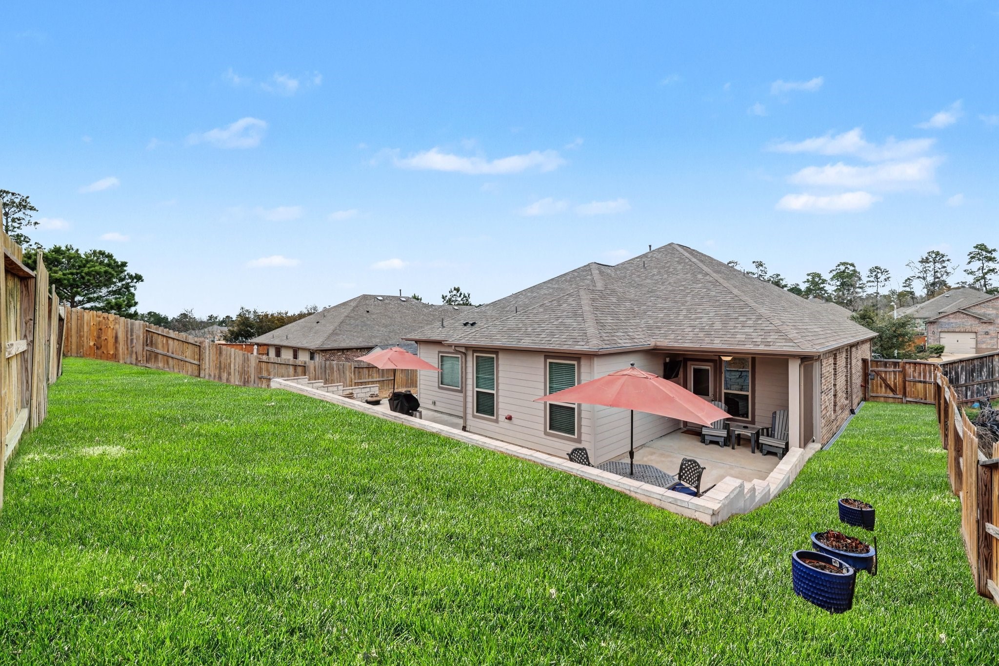 320 Red Maple Lane Conroe, TX 77304 - Photo 20 of 24 Full-property engineered irrigation and drainage system, including terrace, designed to handle high-volume rainfall and efficiently channel water to the street for maximum performance and peace of mind.