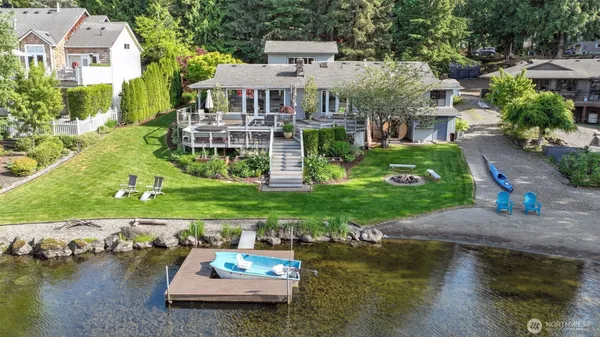 an aerial view of a house with swimming pool patio and lake view