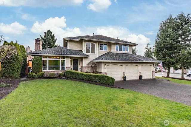a front view of a house with a garden