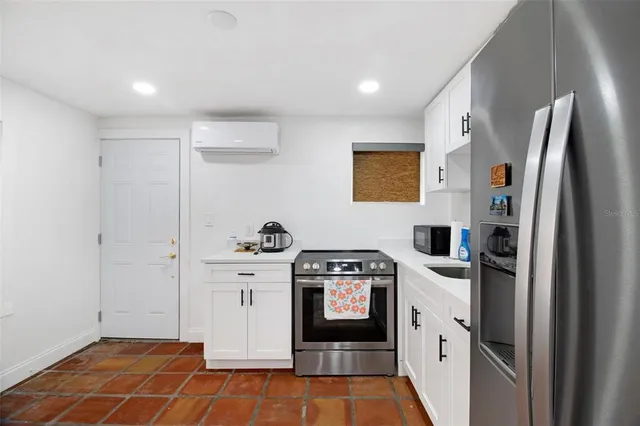 a kitchen with stainless steel appliances granite countertop a refrigerator and a stove