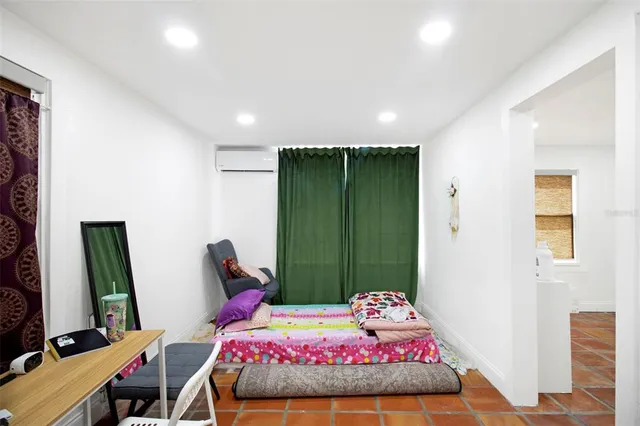 a bedroom with a bed and a mirror