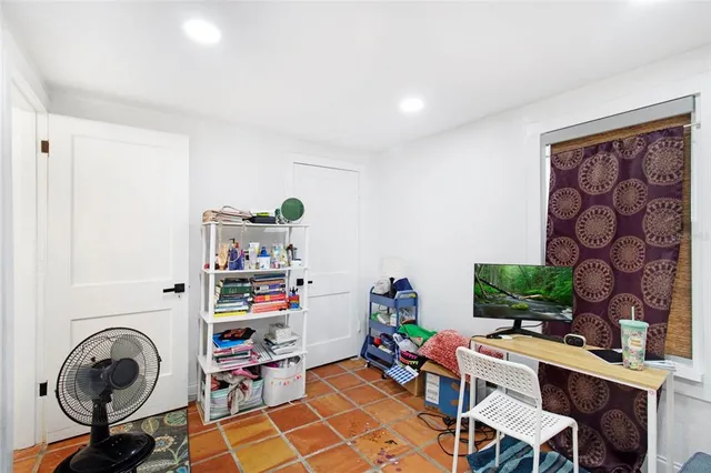 a view of a workspace with furniture and a window