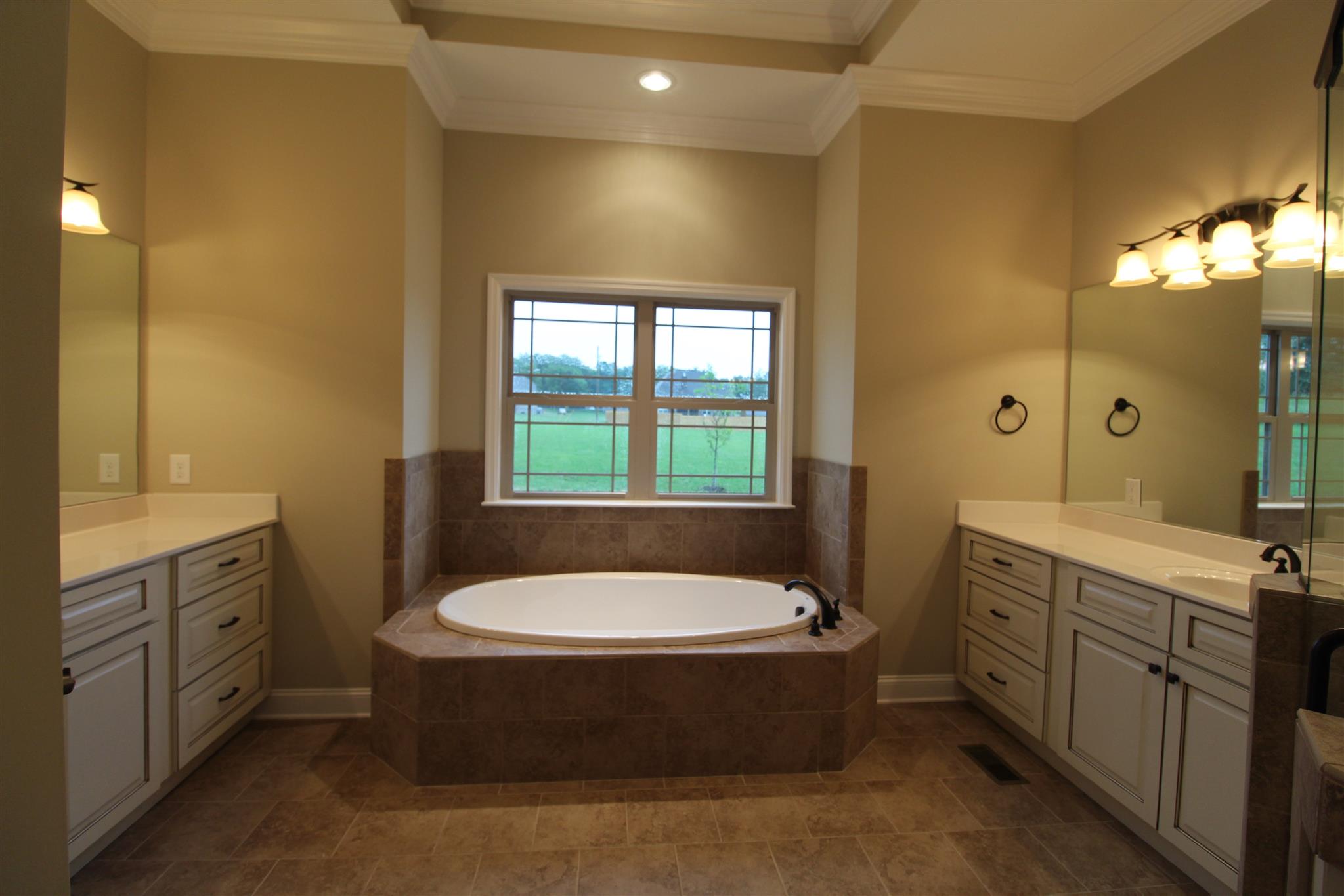 288 Bates Road Lebanon, TN 37087 - Photo 17 of 26 a bathroom with a tub sink shower and mirror