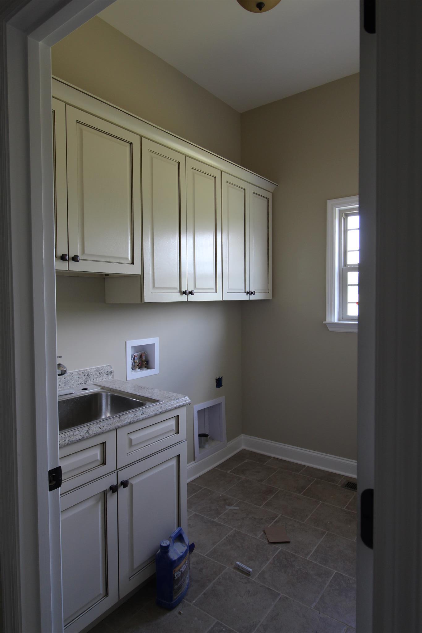 288 Bates Road Lebanon, TN 37087 - Photo 20 of 26 a kitchen with white cabinets and sink
