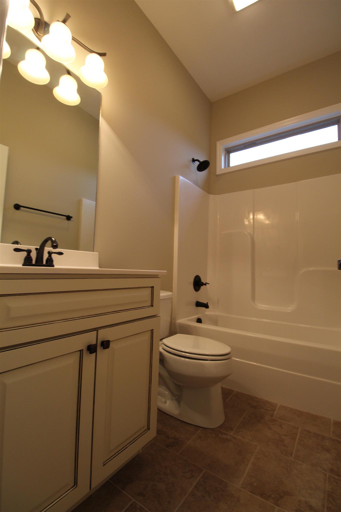 288 Bates Road Lebanon, TN 37087 - Photo 21 of 26 a bathroom with a toilet a sink a mirror and bathtub
