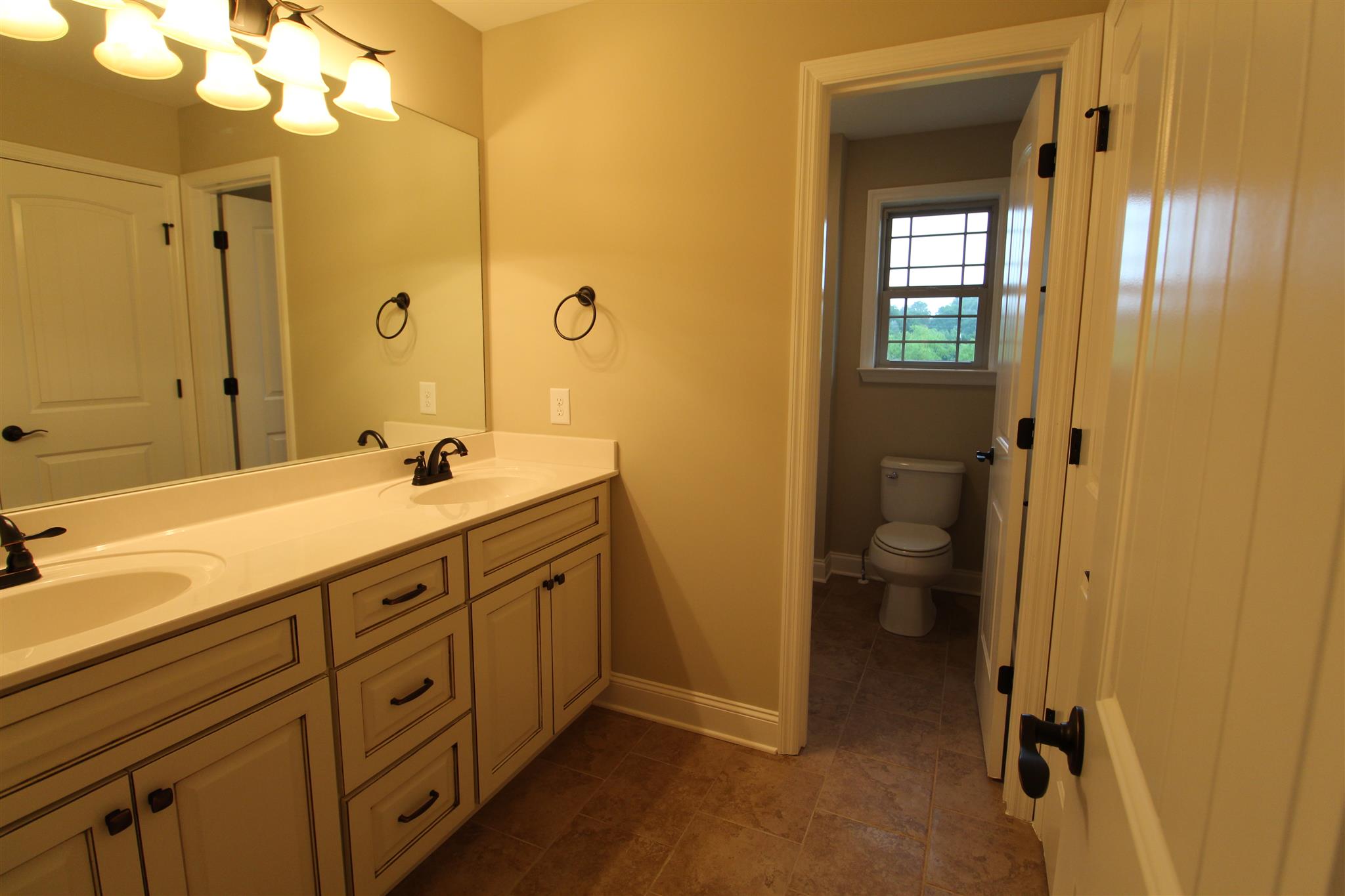 288 Bates Road Lebanon, TN 37087 - Photo 25 of 26 a spacious bathroom with a double vanity sink a mirror and a shower