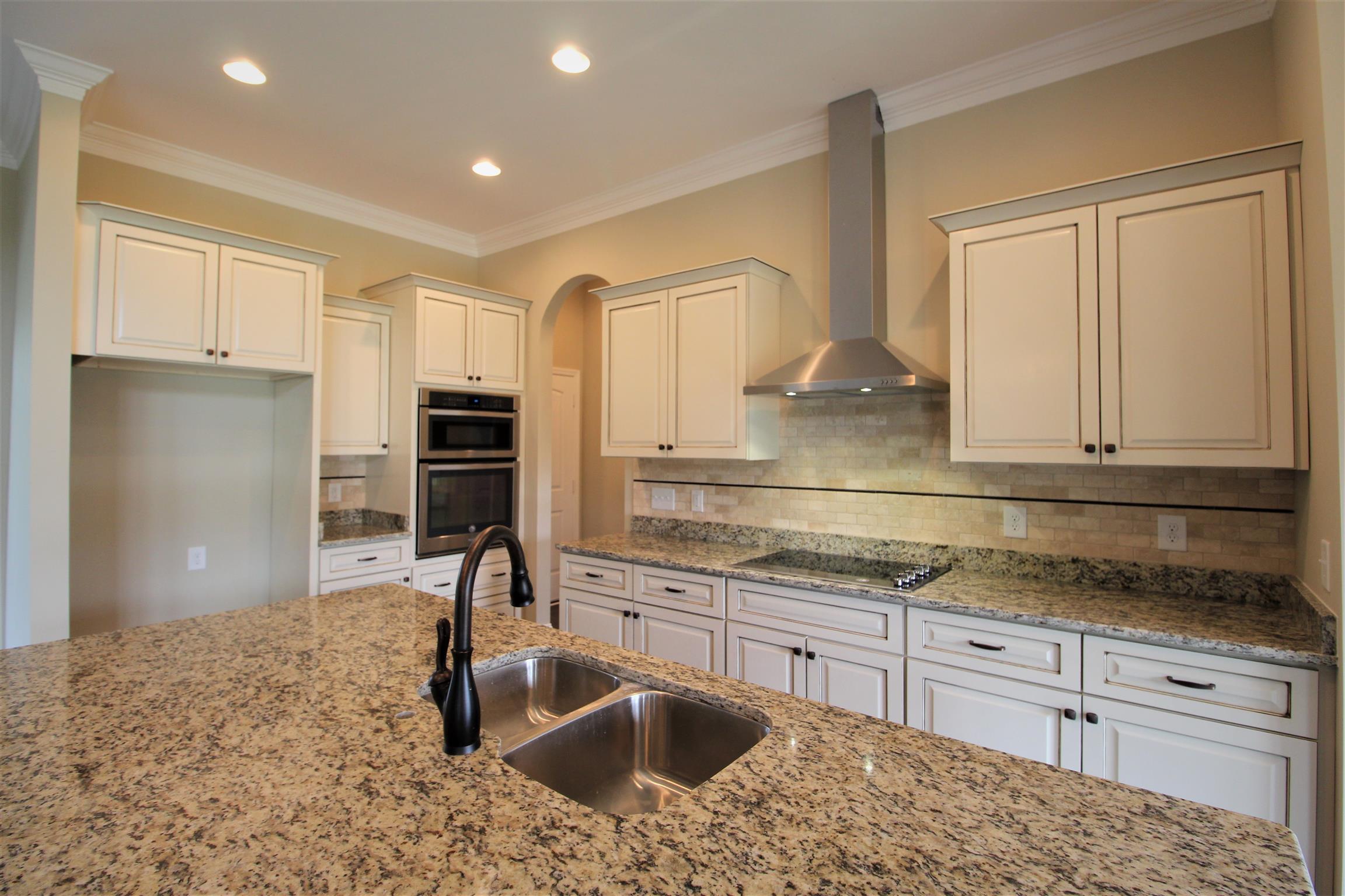 288 Bates Road Lebanon, TN 37087 - Photo 10 of 26 a kitchen with stainless steel appliances granite countertop a sink stove and refrigerator
