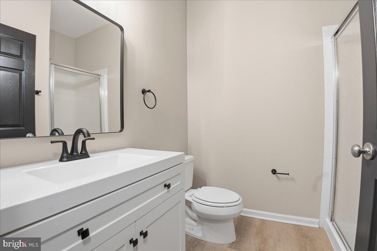 20419 Riverbend Square, Unit 301 Sterling, VA 20165 - Photo 19 of 25 a bathroom with a sink a toilet and mirror