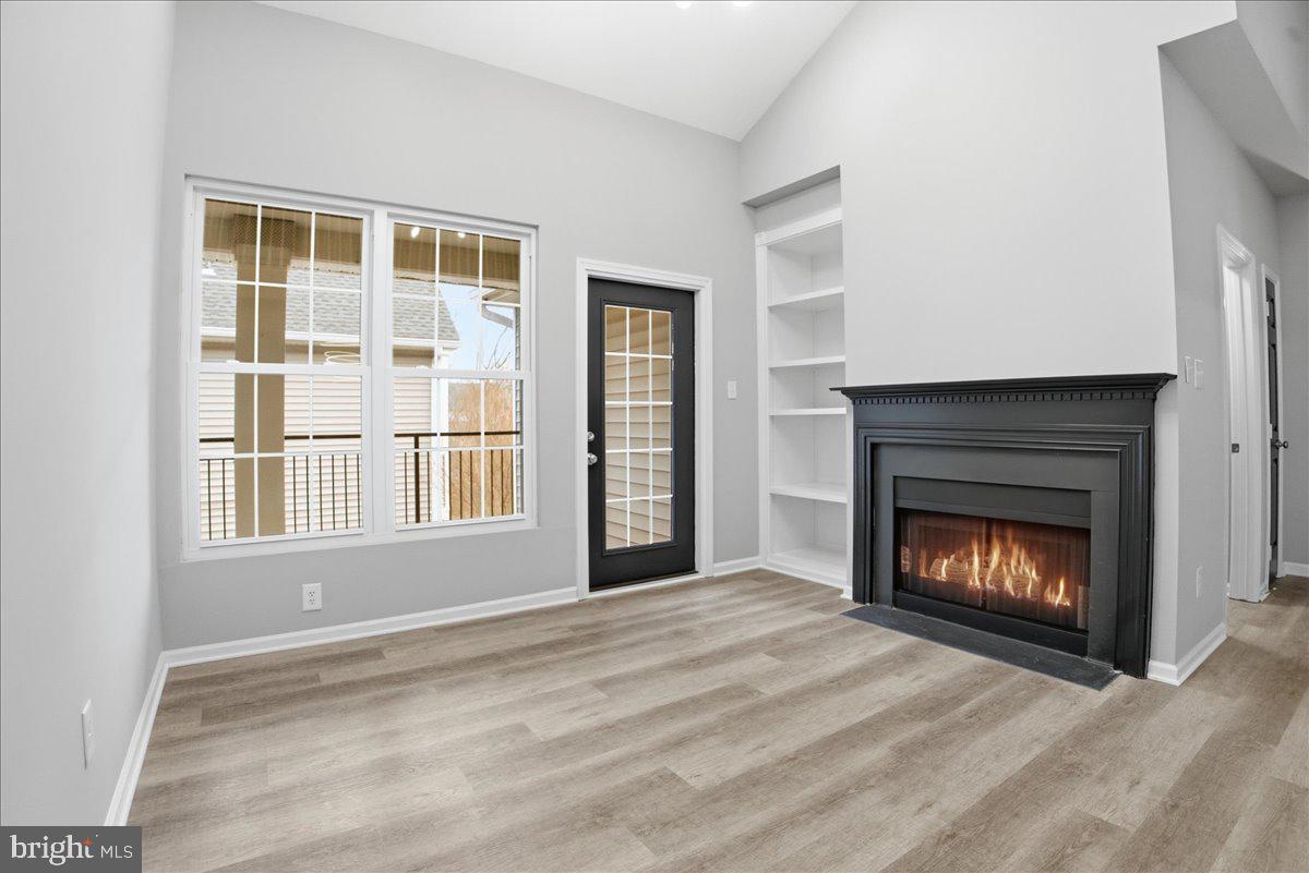 20419 Riverbend Square, Unit 301 Sterling, VA 20165 - Photo 10 of 25 a view of an empty room with a fireplace and window